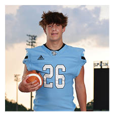 A young man wearing a football uniform and holding a football. AI generated content