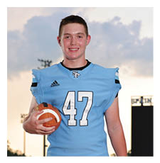 A football player wearing a blue jersey and white pants is holding a football. AI generated content