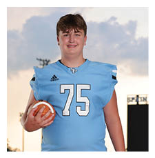 A football player in a blue jersey holding a football. AI generated content