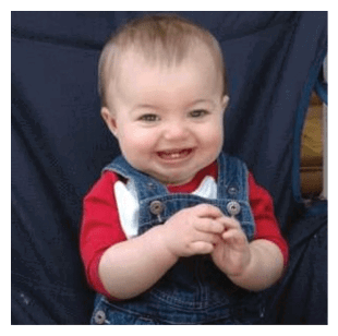 A baby wearing a red shirt and blue overalls is sitting in a chair and smiling. AI generated content