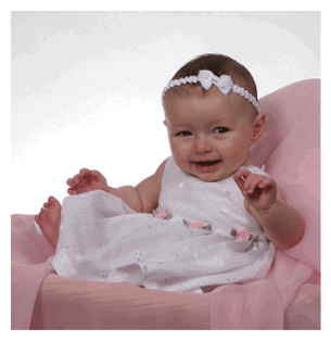 A baby girl is sitting in a pink chair, wearing a white dress and a bow in her hair. She is smiling and appears to be enjoying her time. AI generated content