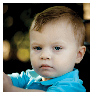 A young boy is holding a toy in his hands. AI generated content