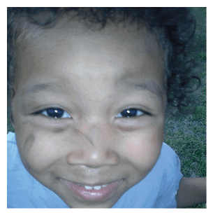 A young boy with a baseball shirt on, smiling and showing his teeth. AI generated content