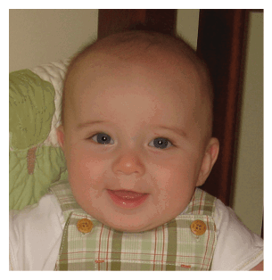 A baby with a green and white plaid bib is smiling and sitting in a high chair. AI generated content