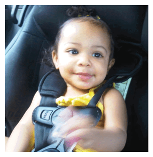 A baby girl is sitting in a car seat, smiling and holding a toy. AI generated content