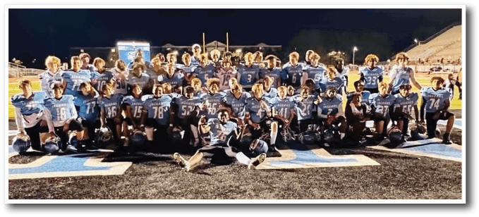 A football team posing for a picture on the field. AI generated content
