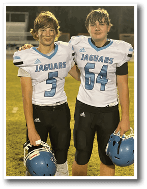 Two football players wearing white and blue uniforms with the number 54 and 54 on their jerseys. AI generated content