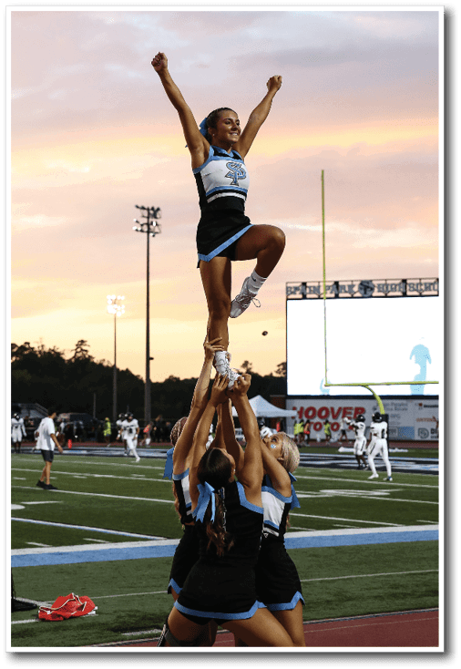 A group of cheerleaders are performing a stunt on the field. AI generated content