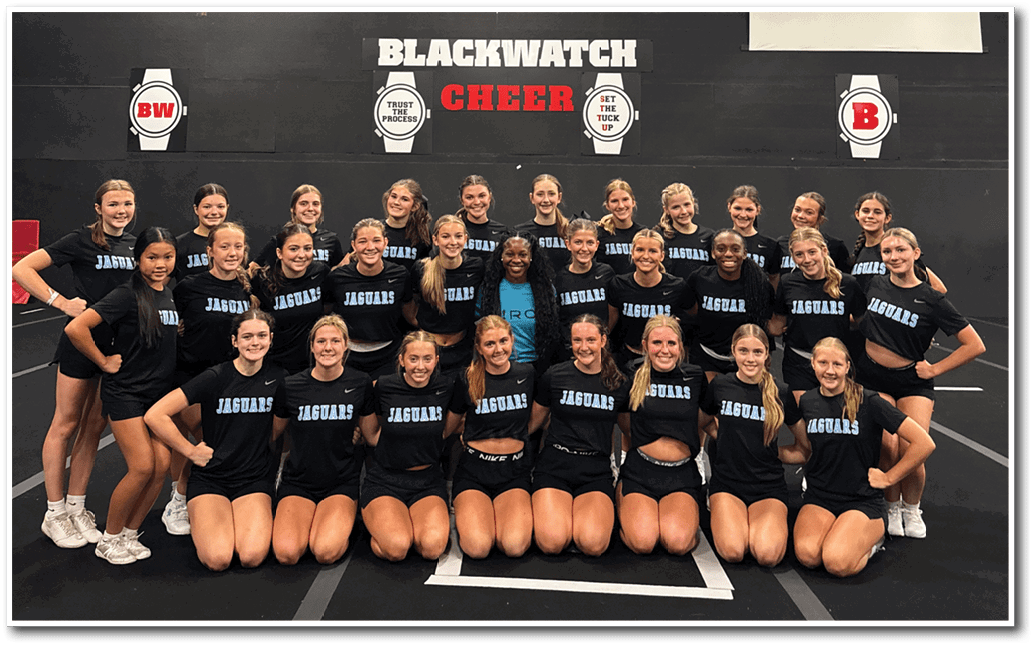 A group of cheerleaders pose for a photo in front of a banner. AI generated content