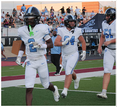 A group of football players running on the field. AI generated content