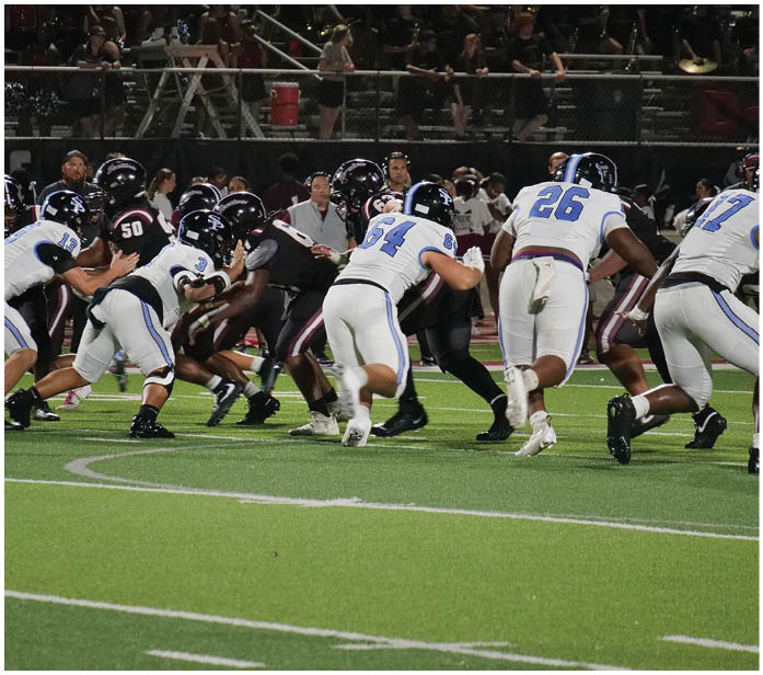 A group of football players in uniforms on a field. AI generated content