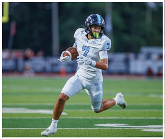 A football player wearing a white uniform is running with a football in his hand. AI generated content