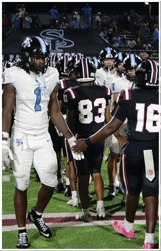A group of football players wearing black and white uniforms are standing on the field. AI generated content