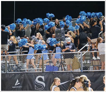 A group of cheerleaders perform in front of a crowd. AI generated content
