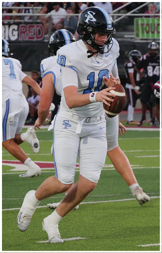 Two football players in white uniforms are running on a field. One player is holding a football. AI generated content
