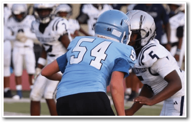 A group of young men playing football on a field. AI generated content