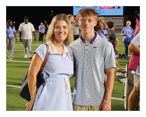 A man and woman pose for a picture on a field. AI generated content