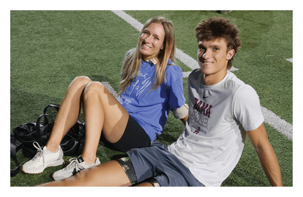 A man and woman are sitting on the grass, smiling and posing for a picture. AI generated content