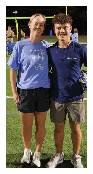 A man and woman pose for a picture on a football field. AI generated content