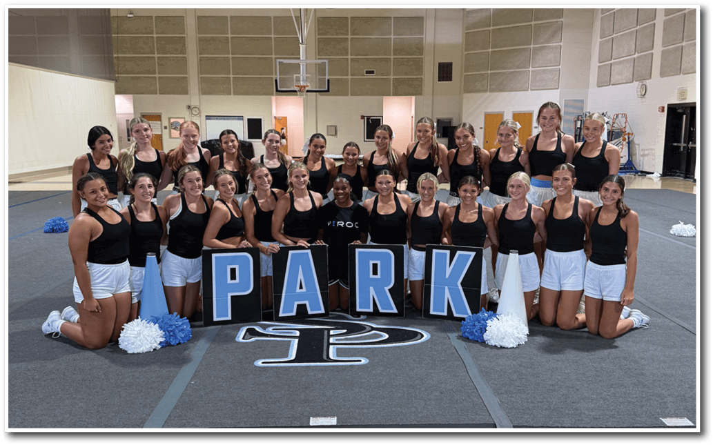 A group of cheerleaders pose for a picture on a basketball court. AI generated content
