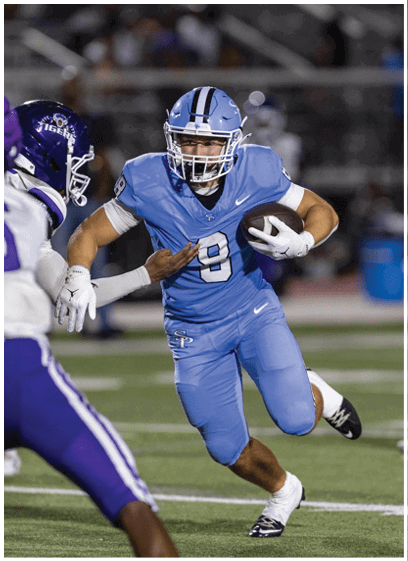 A football player in a blue uniform is running with the ball. AI generated content