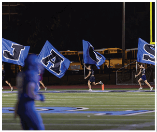 A group of people are running on a field with a banner. AI generated content