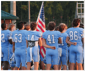 A group of football players stand in formation, some wearing blue and white uniforms. AI generated content