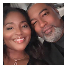 A man and woman are posing for a picture, both smiling. The man has a beard and mustache. AI generated content