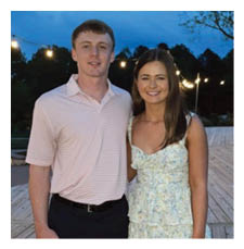 A man and woman pose for a picture on a wooden deck. AI generated content