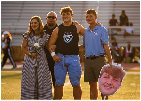 A group of people, including a man holding a football player's head, pose for a photo on a field. AI generated content