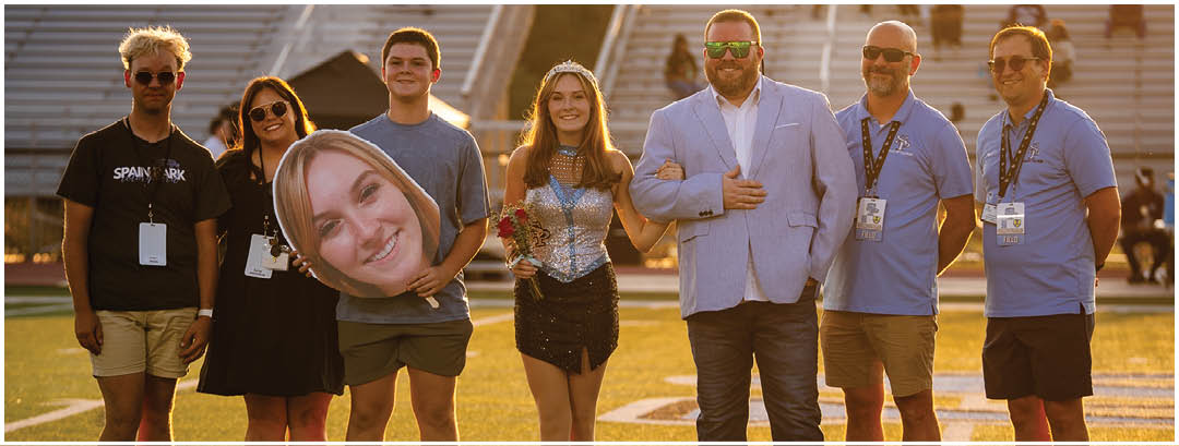 A group of people posing for a photo on a field. AI generated content