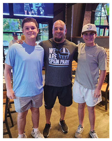 Three people pose for a picture in a restaurant. AI generated content