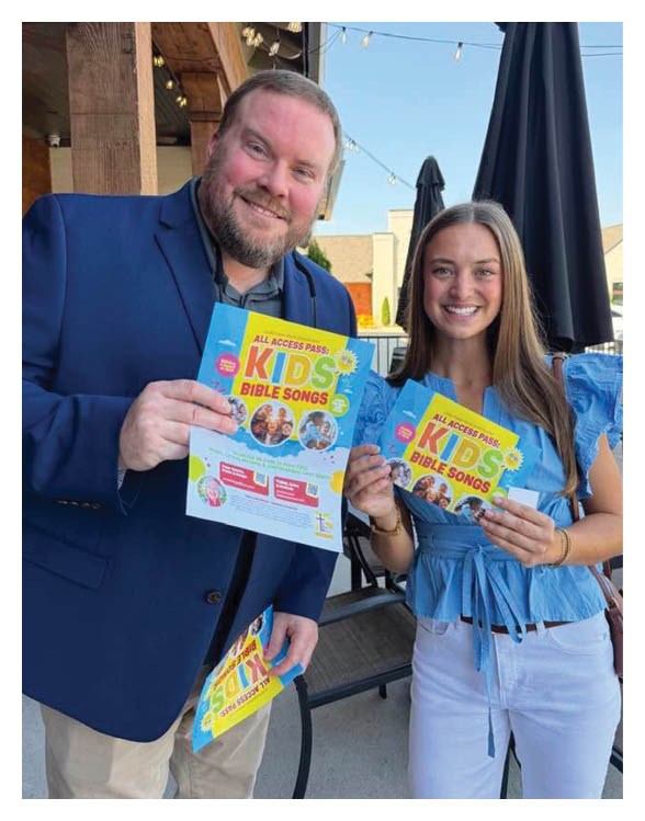 A man and woman are holding up flyers for a kids' event. AI generated content