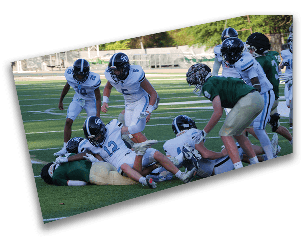 A group of football players on a field, some of them falling to the ground. AI generated content