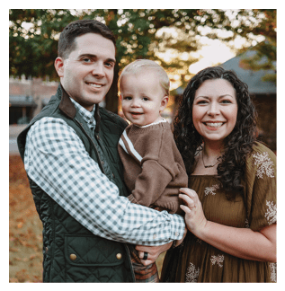 A man and woman are holding a baby in their arms. AI generated content