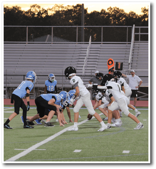 A group of young boys playing football on a field. AI generated content