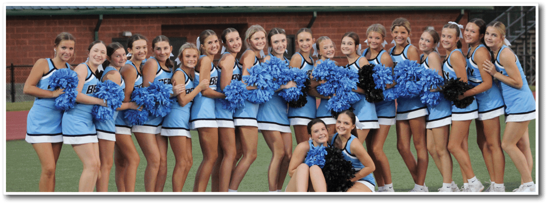 A group of cheerleaders in blue and white uniforms pose for a picture. AI generated content