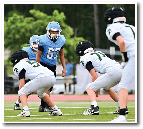A group of young men in football uniforms are on a field. AI generated content