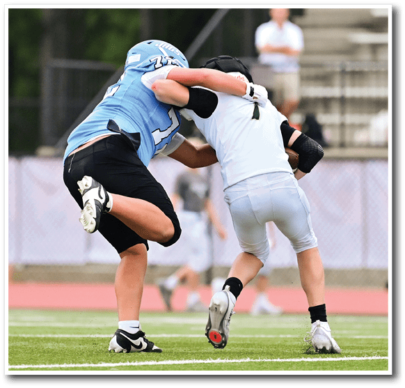 Two football players are fighting for control of the ball during a game. AI generated content