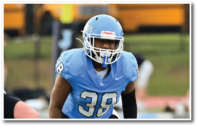 A football player wearing a blue and white uniform stands on the field. AI generated content