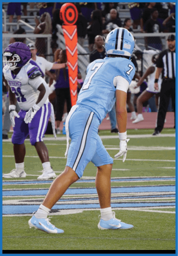 A football player in a blue jersey is running on the field. AI generated content
