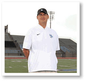 A man wearing a white shirt and black hat stands on a field. AI generated content