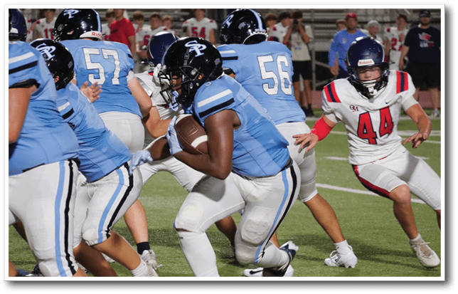 Several people wearing football uniforms are actively running on a grassy field during a game. Description generated by AI