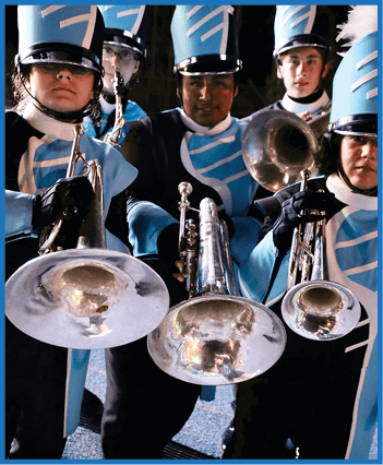 People in blue and white marching band uniforms are playing brass instruments while standing close together. Description generated by AI