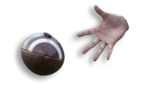 A hand is reaching out to catch a spinning football on a grassy field. Description generated by AI