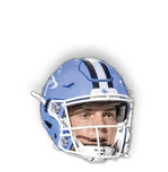 A person wearing a blue football helmet with a white faceguard and a focused expression. Description generated by AI