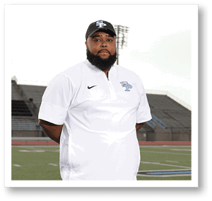 A man wearing a white shirt and a black hat stands on a football field. AI generated content