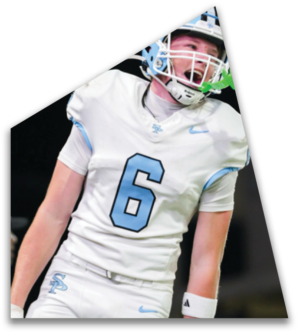 A person wearing a white sports uniform with light blue accents and gloves is captured mid-motion on a field. Description generated by AI