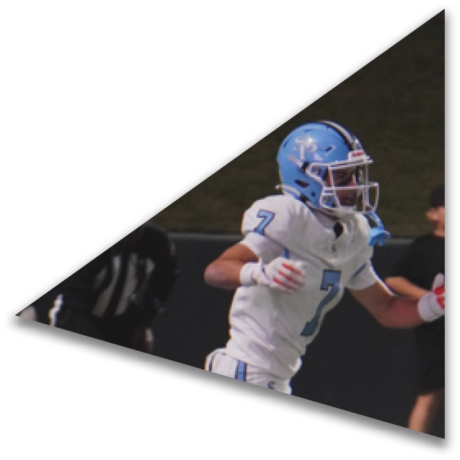 A person in white sportswear and blue shoes is running on a football field near the sideline while three people in black and orange uniforms stand nearby. Description generated by AI