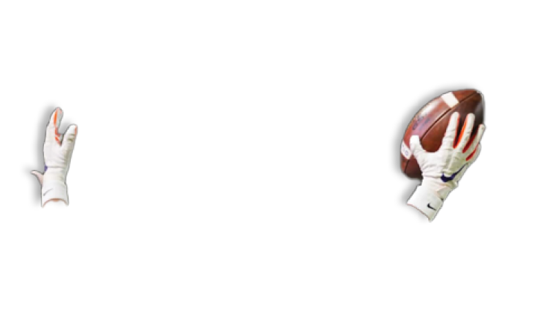 A person wearing a blue helmet and white gloves is reaching up to catch a football in midair against a dark background. Description generated by AI